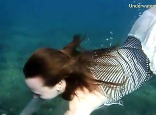Redhead skinny dipping off a boat